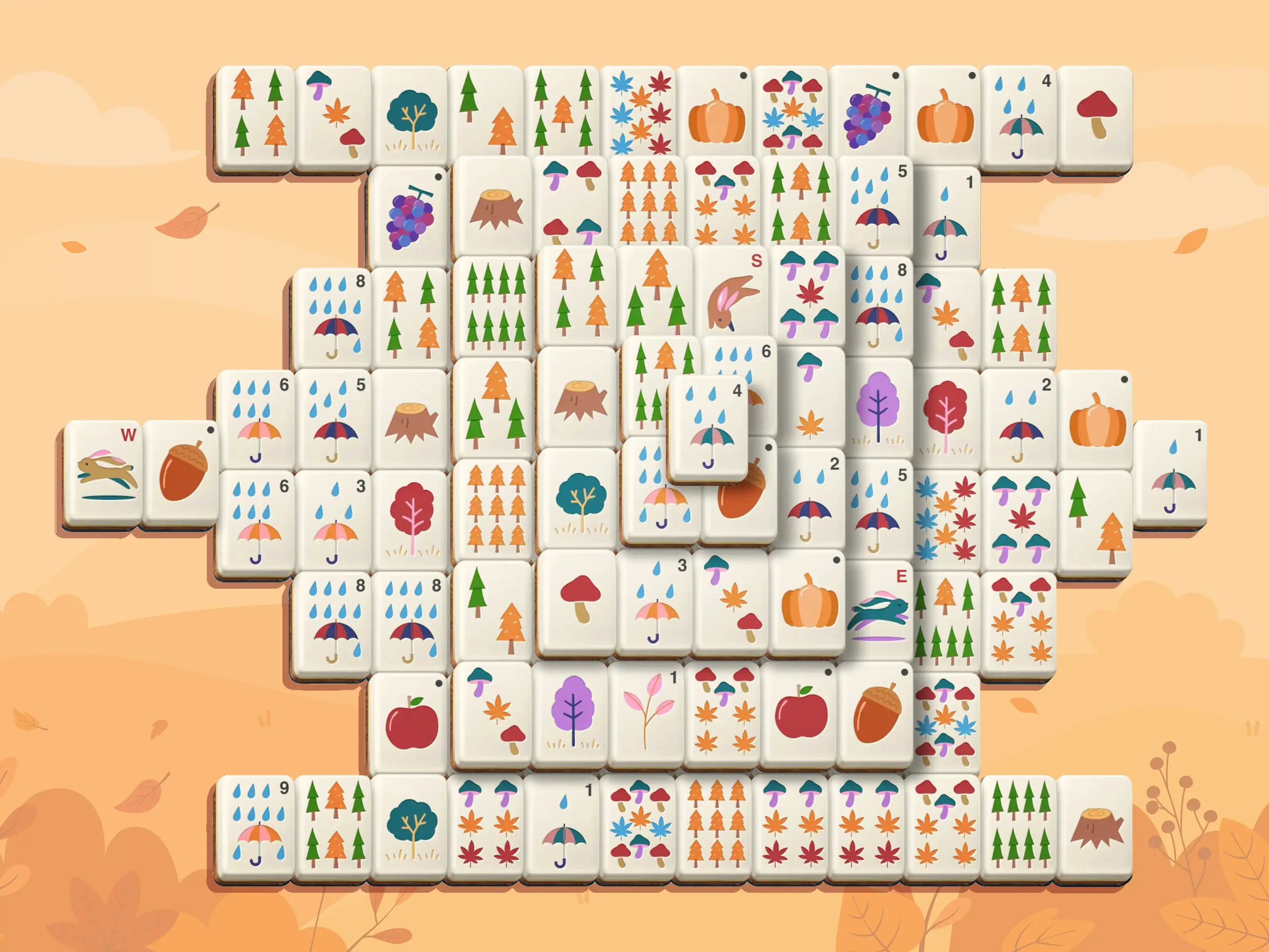 Preview image of the autumn event on TheMahjong.com. The tiles are decorated with seasonal elements such as umbrellas, leaves, pumpkins, mushrooms, trees, acorns, and raindrops.